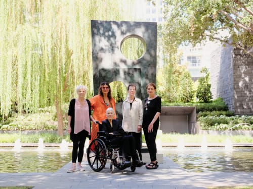 Lita Albuquerque, center, at the Nasher Sculpture Center. Foreground, “Najma Returns (Guardian of the Earth),” 2023. Background, a photo mural of “Untitled,” 1973, by Mary Miss.Credit...Zerb Mellish for The New York Times
