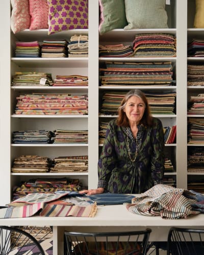 Christine looking at samples and the latest arrivals - for new hand embroidered flat-weaves inspired a Gio Ponti design