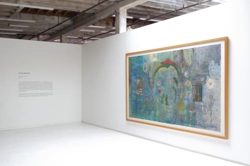 The entry way, on the right: a large painting by William T. Wiley with greens and blues, and in the center a large circular serpent with a fox-like head, devours its own tail.