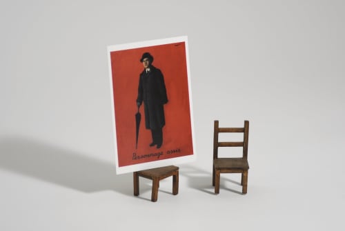 Work by Liliana Porter depicting two tiny wooden chairs and one has small red poster of Renée Maigritte.