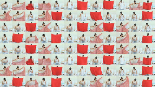 A grid of one woman folding a red sheet, at different times.