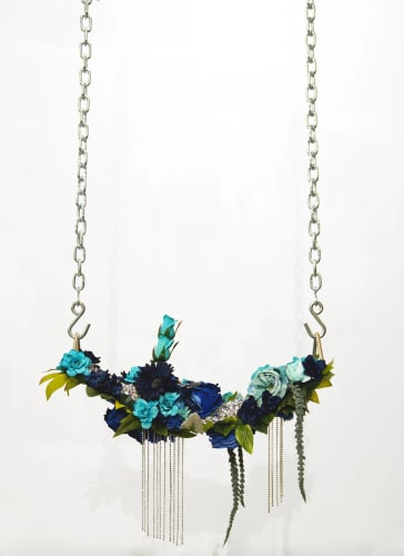 Devan Shimoyama, For Tamir VII, 2019. Silk flowers, rhinestones, jewelry, canvas, found objects and chains on industrial vinyl swing seat, 18 x 22 x 8 in.