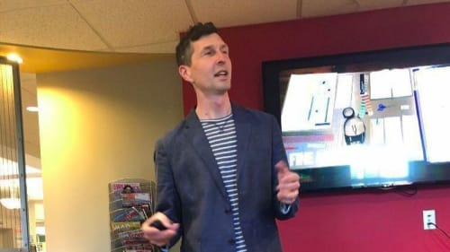 Justin Witte, curator of the Cleave Carney Art Gallery, speaks at the Hinsdale Library. (Sara Clarkson / Pioneer Press)