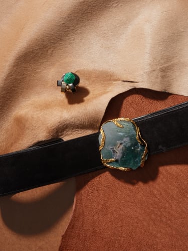 Upper: Sophia Vari, Médée Ring, pre 2010, 18k gold set with a root emerald & ebony, Incised with artist’s signature, numbered & hallmarked. 4.1 x 3.4 x 3.2 cm, 22 g.Edition of 6 + 2 AP. Lower: Andrew Grima, Untitled Belt, 1972, 18k gold belt buckle/ pendant set with a diamond and a large slice of moss agate and with original black leather belt with velcro fastening, from the Louisa Guinness Gallery Archive.