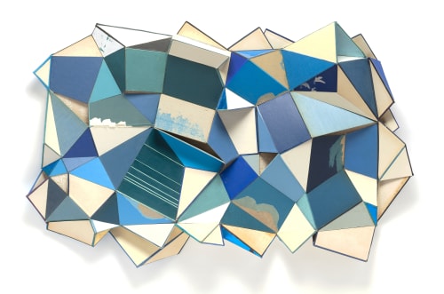 geometric abstract sculpture made of vintage book covers, in blue and white