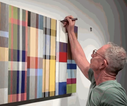 photo of a man painting.