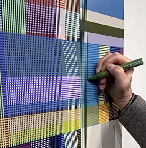 Artist's hand creating abstract painting.