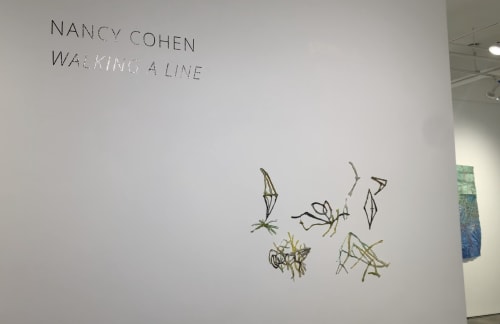Gallery wall with glass art sculpture by Nancy Cohen