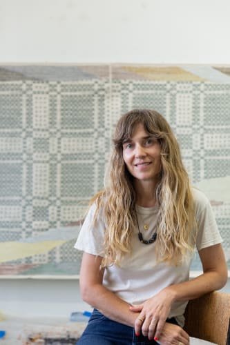 Photograph of Christy Matson in front of her work