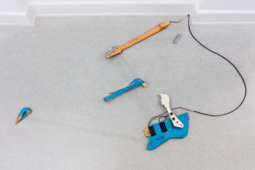 Naama Tsabar, Melody of Certain Damage #13, 2021. Broken electric guitar, strings, microphone, screws and amplifier. 70 x 42 x 3 in. Courtesy of the artist and Shulamit Nazarian, Los Angeles.