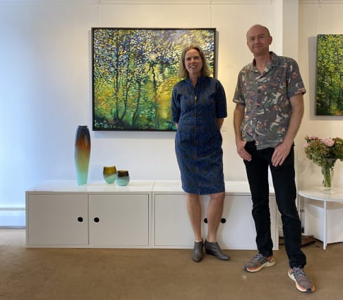 Michèle Oberdieck & Jim Whitty attend opening day of 'Wild Tracks', behind them show their works.