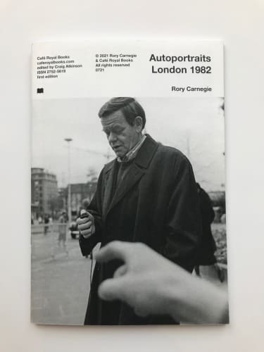 Rory Carnegie book cover of Auto-portraits. A portrait of a man in black and white on the street, holding the camera trigger.