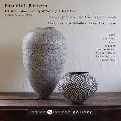 Two black and white ceramics vessels by Ant & Di Edmonds displayed on a wooden table