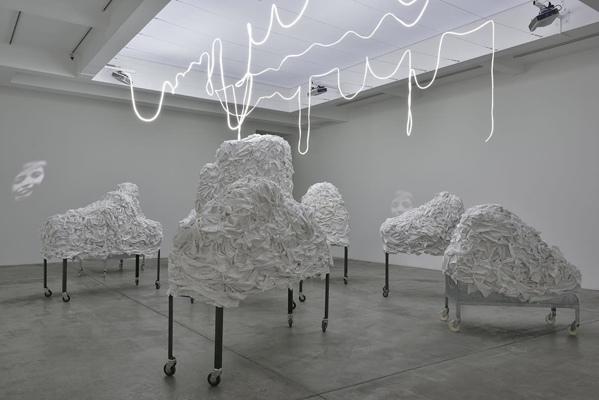 Christian Boltanski Les Linges, 2020 Metal tables on wheels, cardboard, cotton cloth, staples, neon flexible LED Dimensions variable
