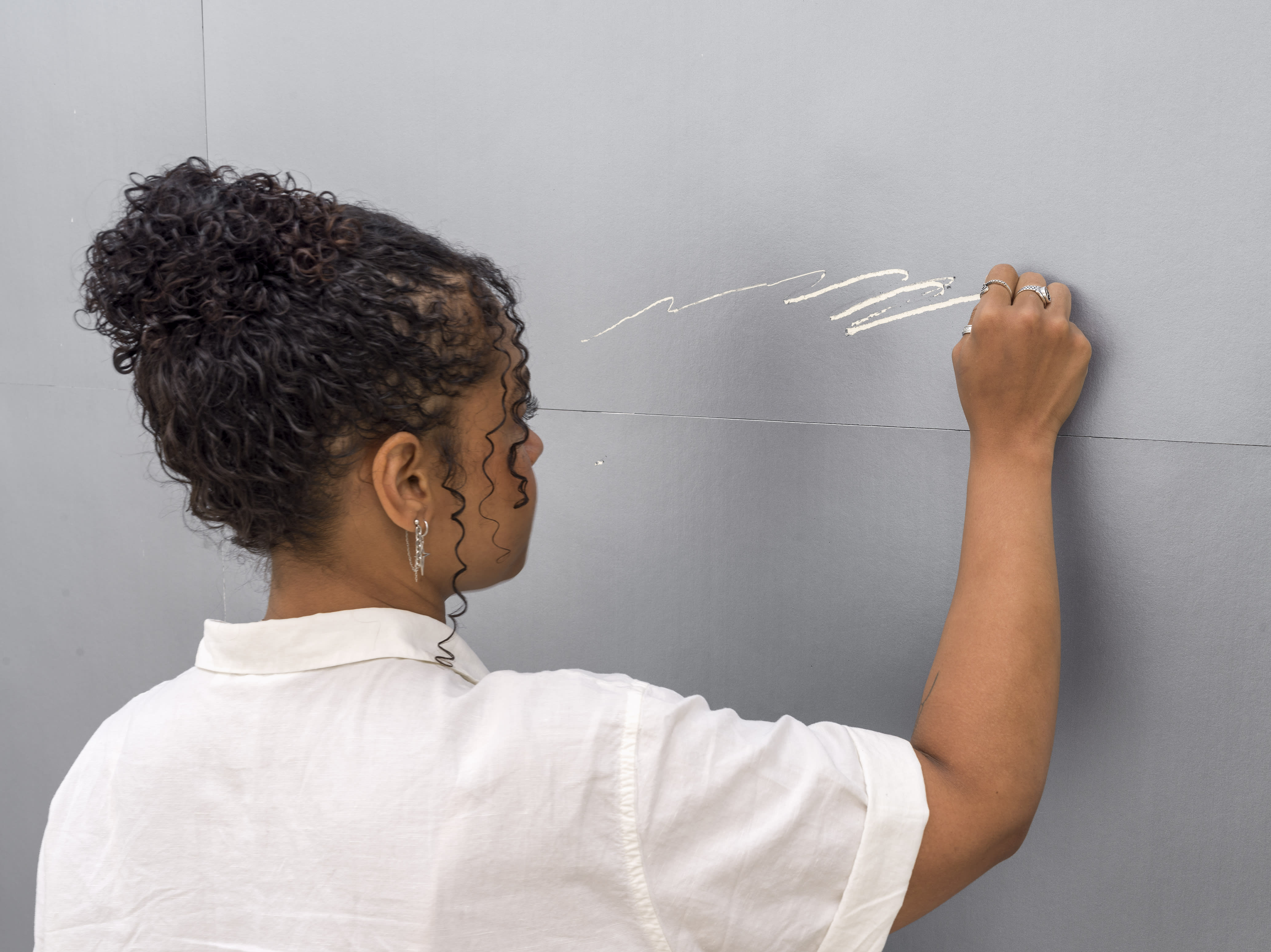 In Autumn Knight's Lottery Tickets, 2023, a participant takes on the “work” of the mark making.