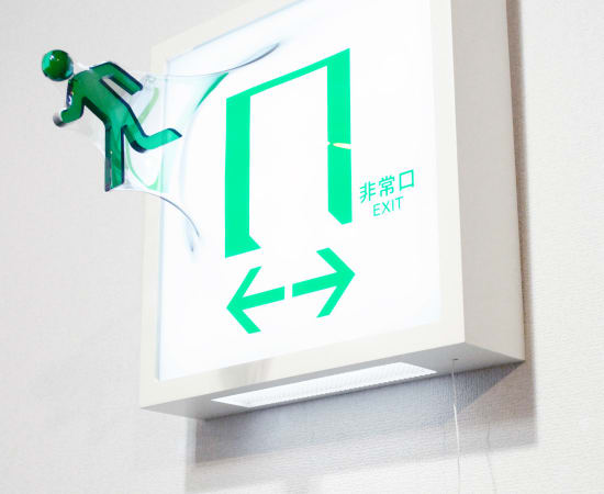 3D exit sign wall sculpture made with Mixed media