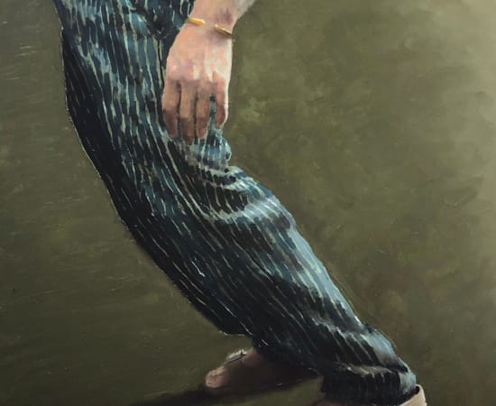 Mans legs in striped trousers on green background