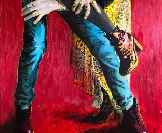 Man and woman's legs intertwined on red background