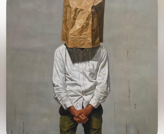 Man with brown paper bag over his head 