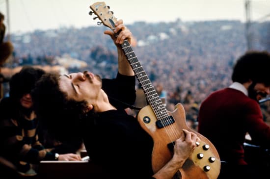 Jim Marshall, Carlos Santana playing guitar during a show