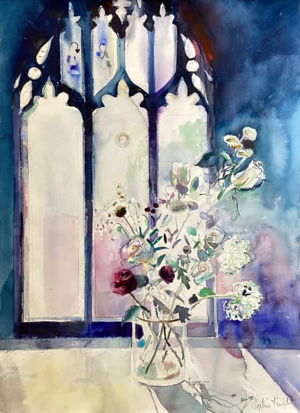 Ranunculus and white roses in light from stained glass window