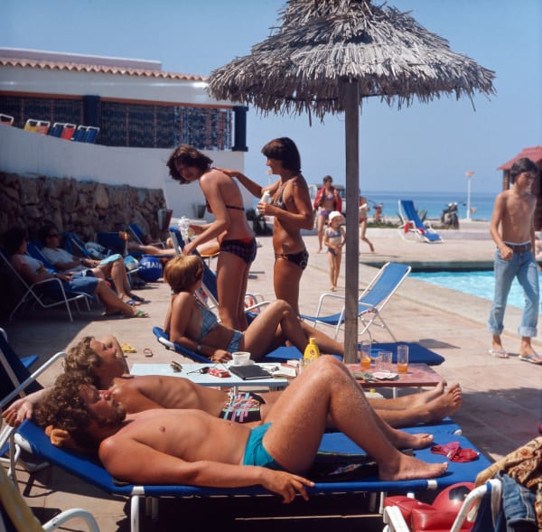 Walter Rudolph, Holiday guests sunbathing at a resort in Formentera, Spain, 1976