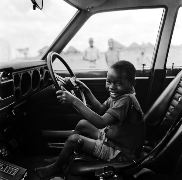 Mohamed (Mo) Amin, Boy enjoying his car ride, 1970/1980