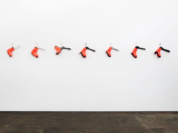 TOREY THORNTON WHO'S TEACHING TO HANG DRY? (ALL RIGHTS AND 1 LEFT, INTRO TO SEVEN DEADLY SINS), 2020 Designer garment hangers, Swedish cycling thermal and rain booties of neoprene Polyurethane and Kevlar 14 x 172 x 4 in 35.6 x 436.9 x 10.2 cm