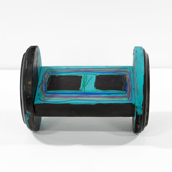 A small wooden sculpture that looks like a hoverboard colored in with marker.