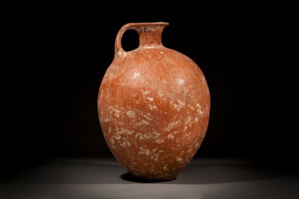 A Large Canaanite Red Slip Burnished Wine Jug, Early Bronze Age I, 3500 B.C.E. - 3000 B.C.E.