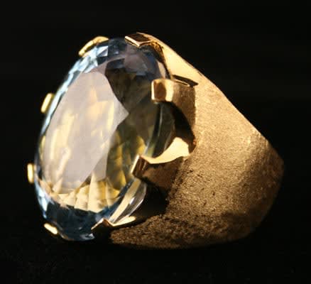18 Karat Gold Ring with a Florentine Finish Featuring an Aquamarine