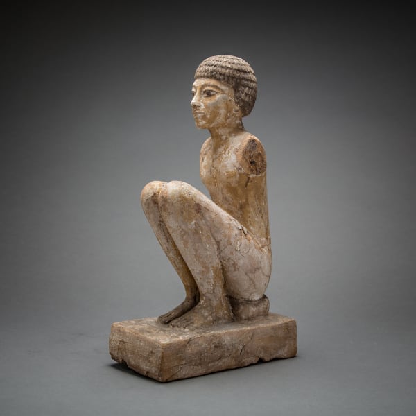 Ancient Egyptian wooden statue of a seated male