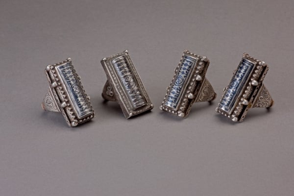 Four oblong engraved silver rings