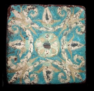 Assyrian Glazed Brick Tile Depicting a Floral Motif