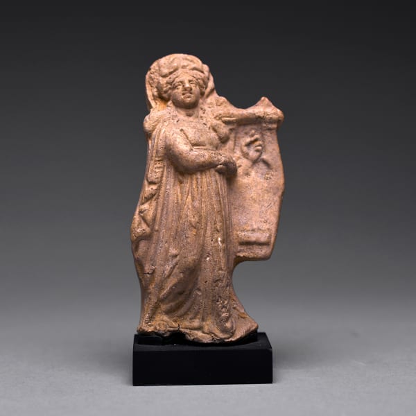 A Hellenistic Terracotta Statue of a Woman Holding a Lyre-Like Instrument