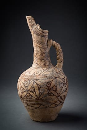 Terracotta painted ewer with elaborate handle