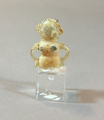 Small glass figurine of a woman with applied blue glass trail