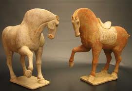 A Pair of Tang Dynasty Red and White Painted Pottery Prancing Horses