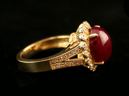18 Karat Gold Ring Featuring a Cabochon Ruby with 50 Diamonds