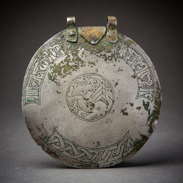 Silver round incised cover with mythological animal