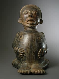 Seated Figure With Hands Placed On The Stomach