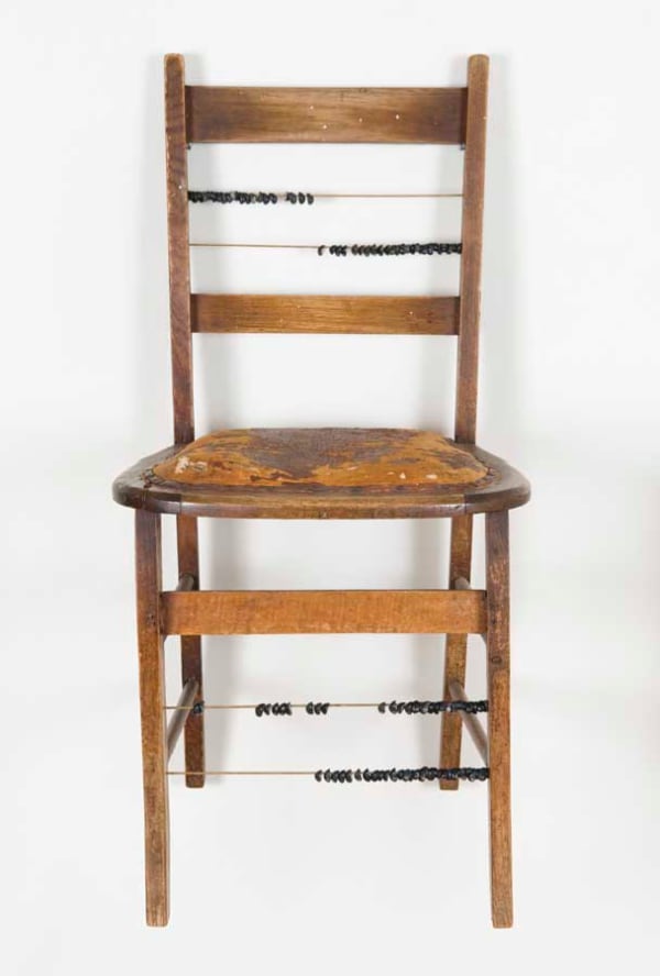 Julie Gough Head count, 2008 Found chair with brass rods & black crow shells 85.5 x 43 x 43 cm