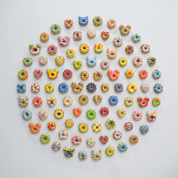Individually made ceramic glazed donut wall sculptures with unique colors and shapes