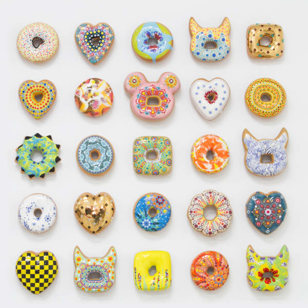 Individually hand glazed and painted cermaic donuts in unique colors and shapes
