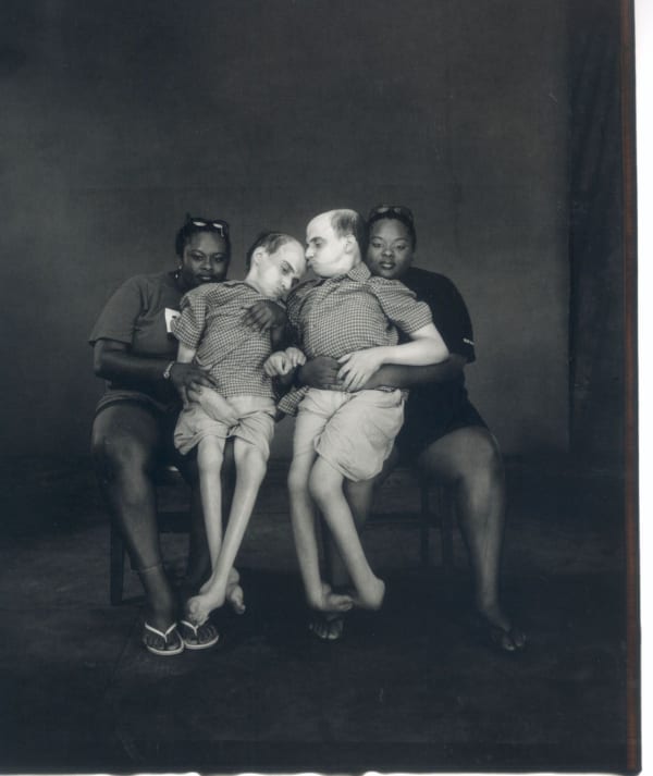 Bruce and Brian Kuzak, with their nurses, Teresa and Tillie Merriweather