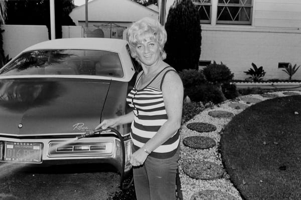 Untitled (woman watering, striped top)