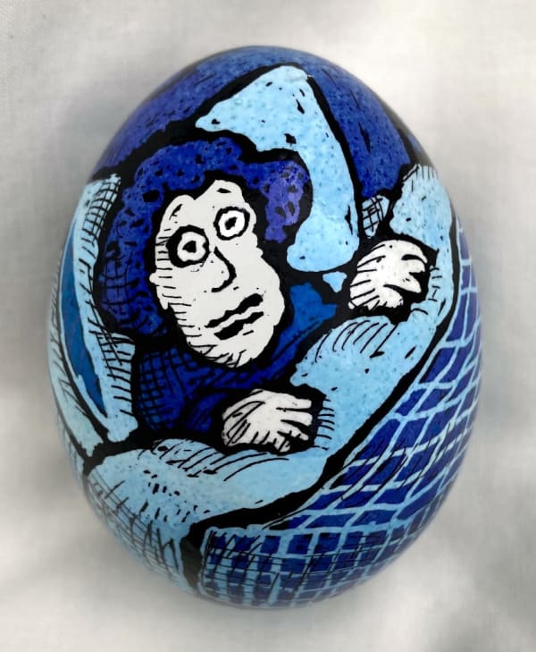 dyed egg showing woman in blue bed