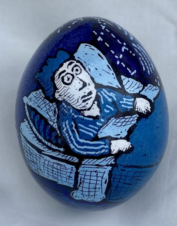 Pysanky egg showing man lying in blue bedroom