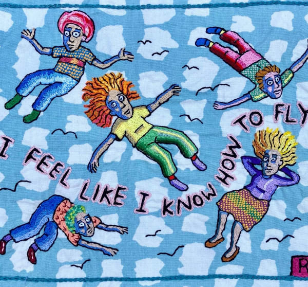 embroidery showing people floating and flying in air