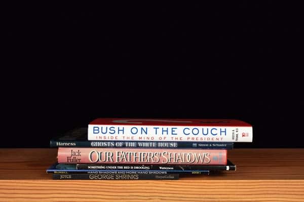 Nina Katchadourian, Bush on the Couch from the series Family Gathering, 2013 ("Sorted Books" project, 1993-ongoing), 2013
